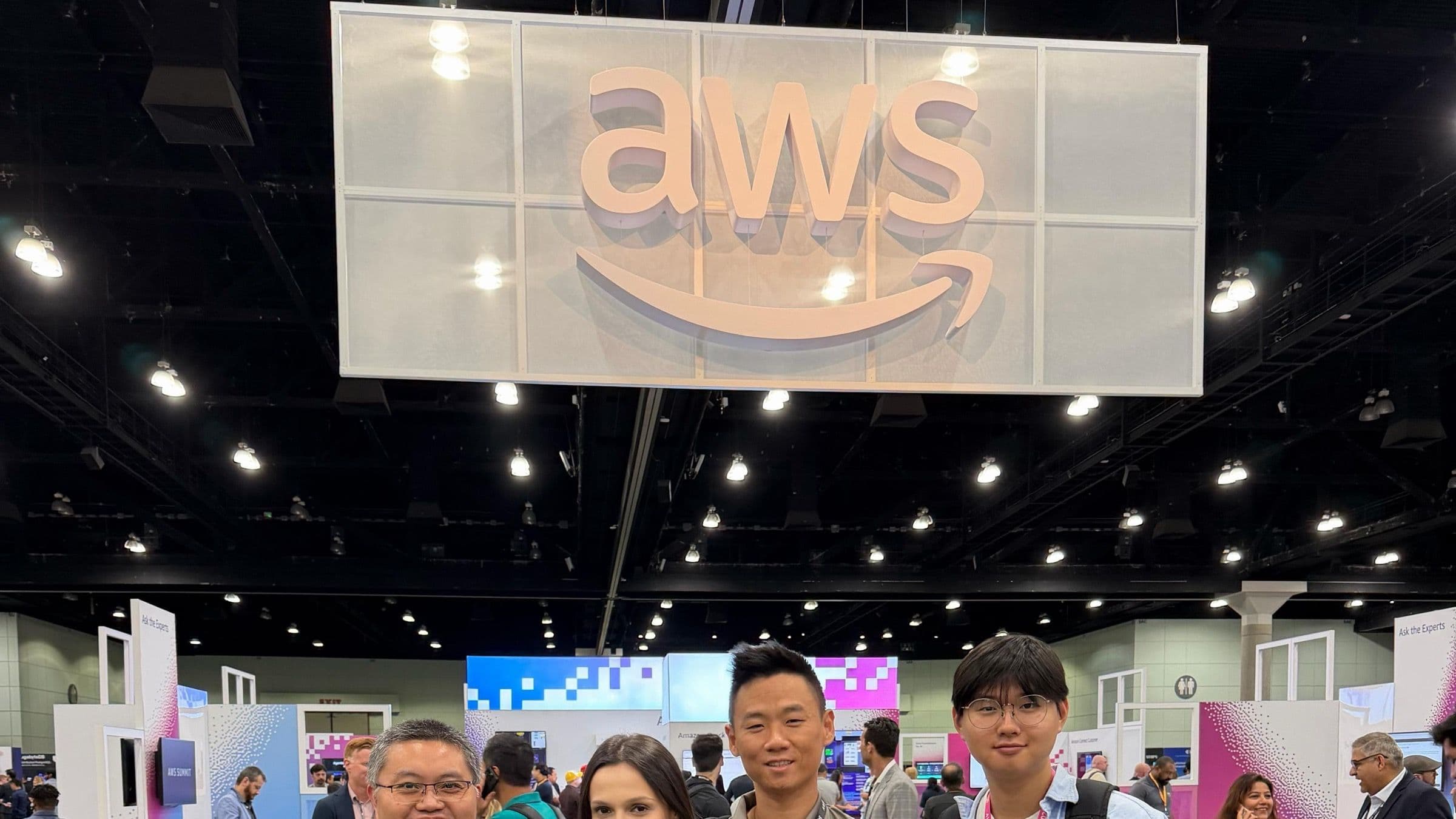 The Patriot Conceptions team beneath the AWS sign at AWS Summit Los Angeles.