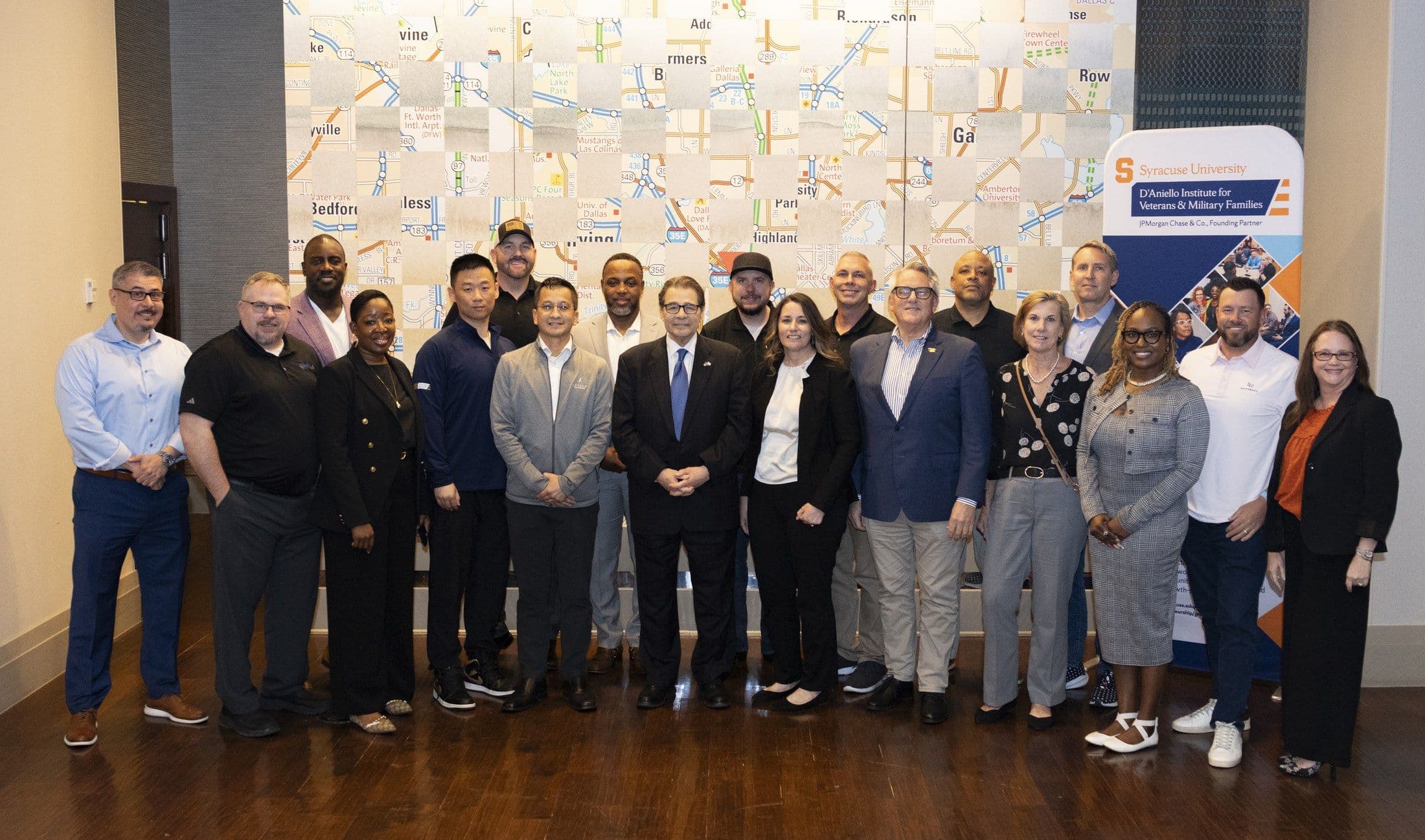 Veteran entrepreneurs and partners gathered at the D'Aniello IVMF backdrop.