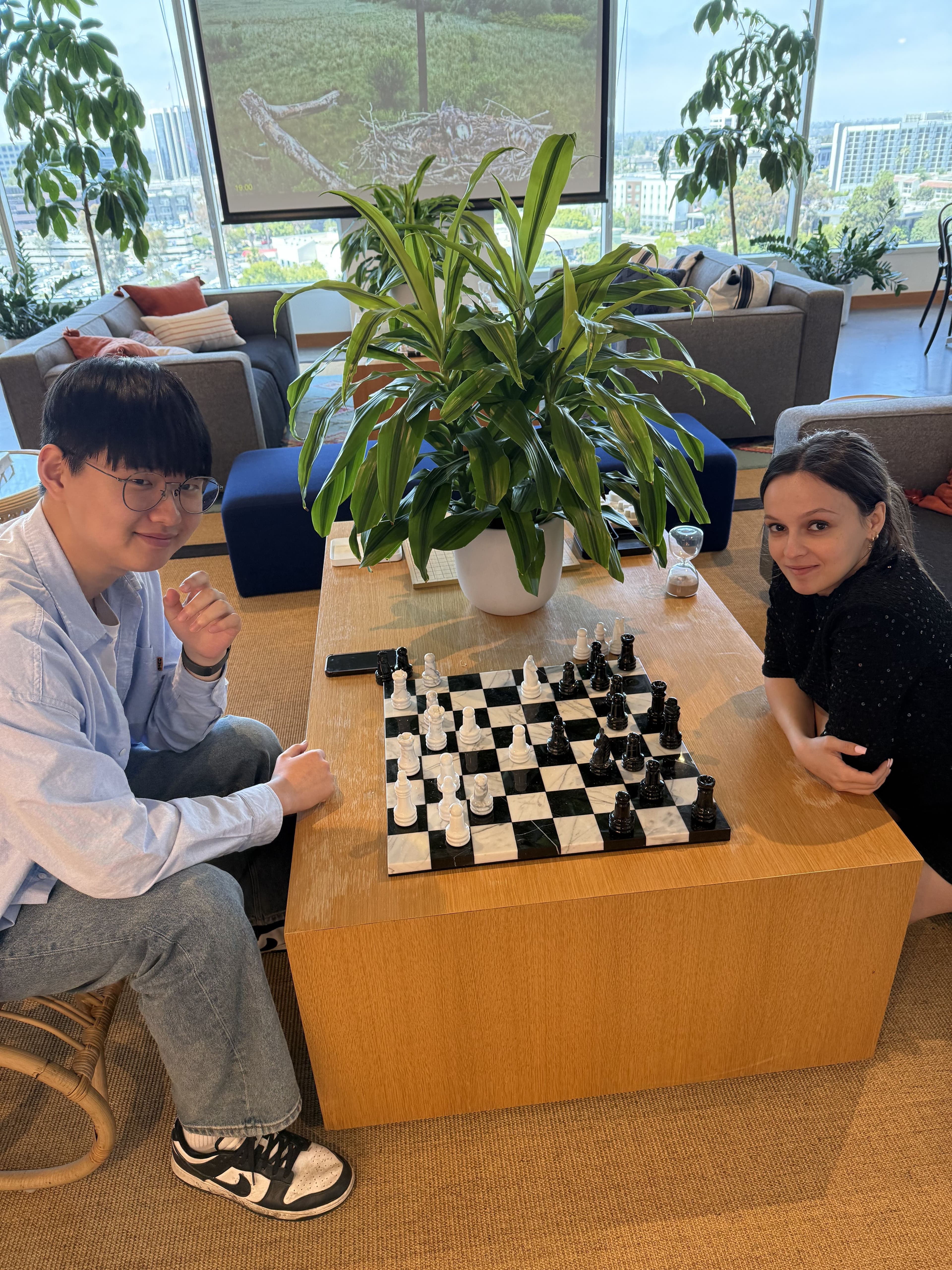 Justin playing chess at the Patriot Conceptions office during his first summer internship, a better metaphor for building than any rivalry scoreboard.